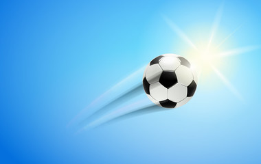 Fototapeta na wymiar Fußball im Flug mit Sonne am Himmel 