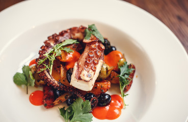 The process of eating the delicious grilled octopus. jukkumi bokkeum is korea traditional webfoot octopus with vegetable stir fry.