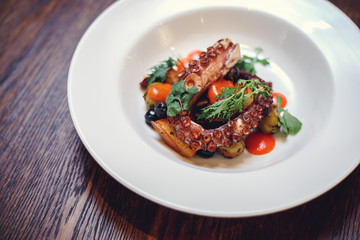 The process of eating the delicious grilled octopus. jukkumi bokkeum is korea traditional webfoot octopus with vegetable stir fry.