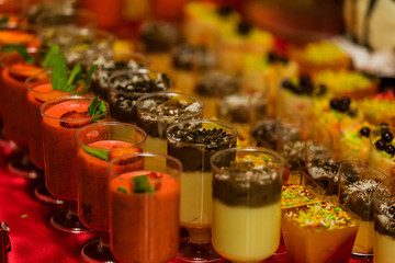 Buffet mousse dessert in a little glass topped with chocolate chips. Dessert canape. Strawberry mousse