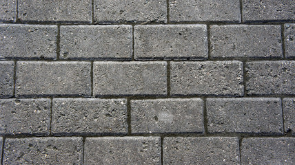 Obraz premium Gray brick stone road. Pavement texture photography.