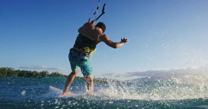 Young Man Kite Surfing in Slow Motion Catching Air on Surfboard