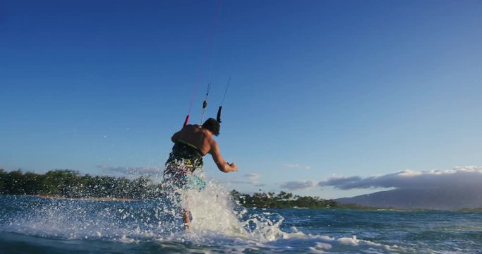 Young Man Kite Surfing in Slow Motion Catching Air on Surfboard