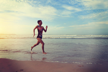Fototapeta na wymiar young fitness woman wear swimsuit running on beach