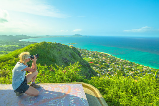 Travel photographer takes shot of Lanikai Beach and Kailua Beach in Oahu East shore, Hawaii, USA. Nature photographer taking pictures outdoors during hawaiian hiking Lanikai Pillbox Hike.