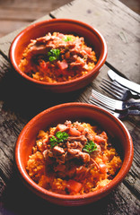 Latin Rice with Roasted Pork on Old Wooden Table