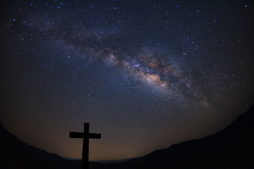 Silhouette of cross over milky way background,Long exposure photograph.