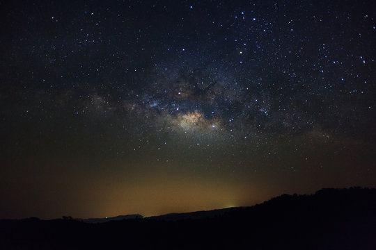 Milky Way over mountain at Phu Hin Rong Kla National Park,Phitsanulok Thailand, Long exposure photograph.with grain