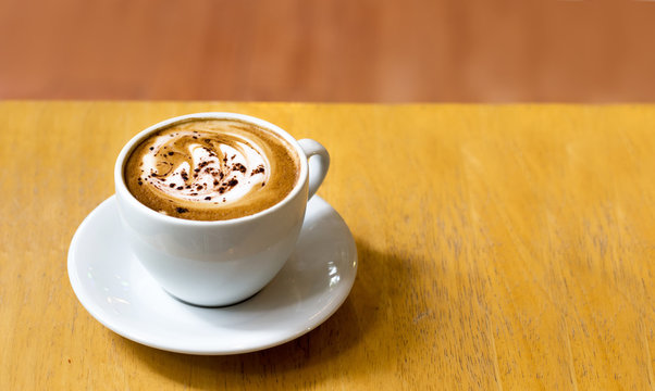 latee art coffee on wood table