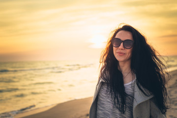 Brunette girl on the background of the sea sunset
