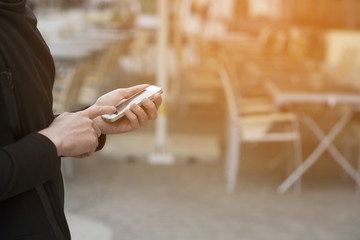 Obraz premium Man holding a smartphone and using it