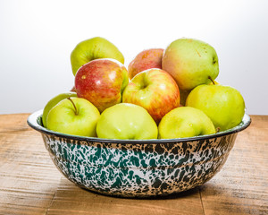 Bowl of organic apples on table