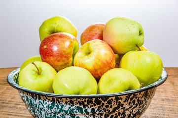 Bowl of organic apples on table