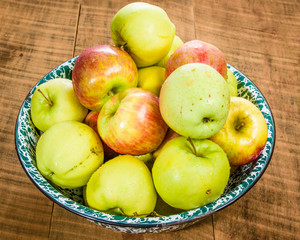 Bowl of organic apples on table