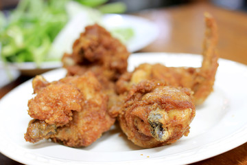 Spicy Deep Fried Breaded Chicken Wings in white dish on the table for dinner.
