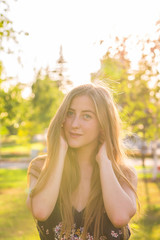 Fototapeta premium Beautiful young woman in the park. Outdoor portrait