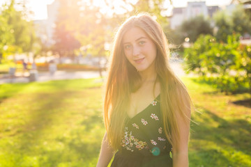 Beautiful young woman in the park. Outdoor portrait