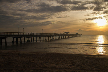 Fototapeta na wymiar Long pier on sunrise beach