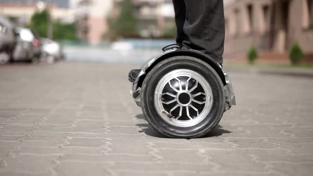 Riding Hoverboard or Electric Self Balancing Gyro Scooter Board on the Side Walk