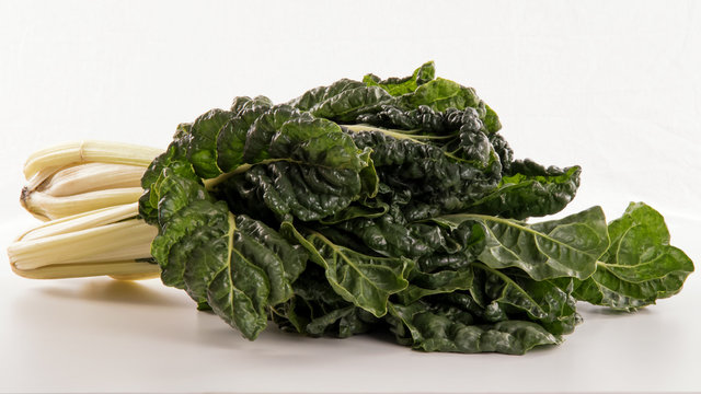 Close up of two bunches of silverbeet, chard or swiss chard on white background