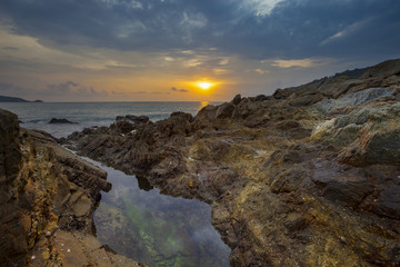 Fototapeta premium Seascape with rock in beautiful sunset scenery background.