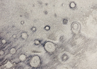 Nature drawing bubble like pattern on sand beach background