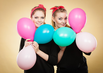 Fototapeta na wymiar Retro girls preparing balloons birthday party.
