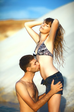 Man kissing girl on beach