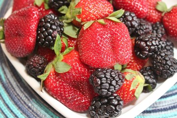An assortment of berries; fresh, ripe strawberries and blackberries