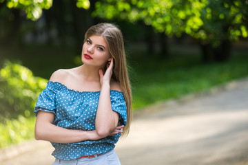 Fototapeta premium Beautiful young woman in the park.