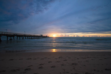 Sunrise and pier in the beach