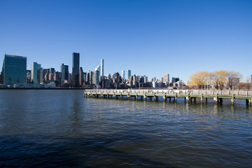 Fototapeta na wymiar Pier on East river and buildings in Manhattan