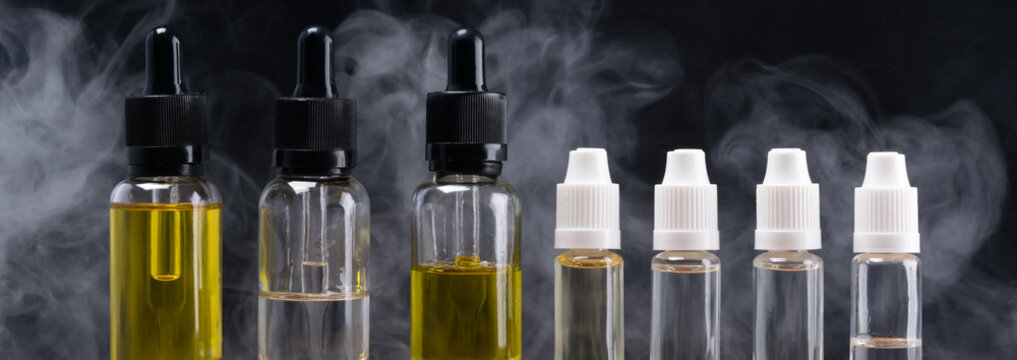 bottles with different flavors for electronic cigarettes, on the background pair