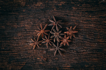 Anise stars on wood background.