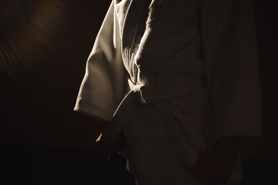 Young girl dressed in hakama practicing Aikido