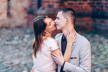 beautiful couple kissing on the street in summer