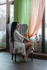 Obraz premium Beautiful girl near the window in the morning
