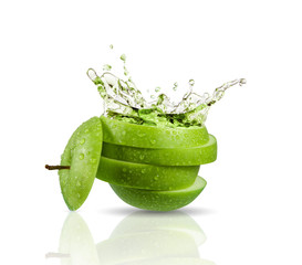 Green apple juice splashing with its fruits isolated on white background