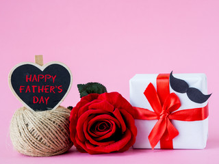 Father's day concept. Happy Father's Day message with red rose on pink background