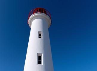 white lighthouse on blue sky