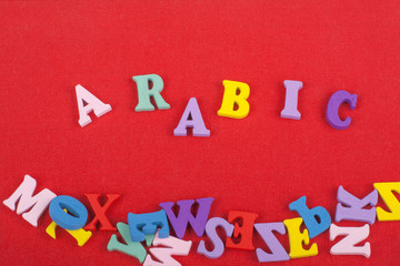 ARABIC word on red background composed from colorful abc alphabet block wooden letters, copy space for ad text. Learning english concept.