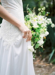 Wedding day. Bride in white dress with beautiful wedding bouquet.