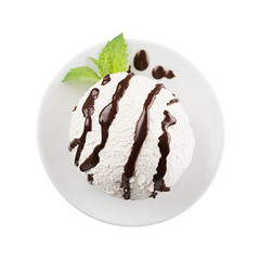 White creamy ice cream scoop with chocolate sauce and fresh green mint on white plate isolated, closeup. Template for restaurant menu.