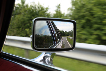 Road in car mirror