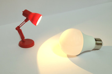 Red lamp lightening warm white light with a bulb