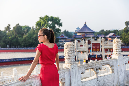 Woman relaxing enjoying scenic view at religious tourist attraction in Beijing, china. Asia travel old temple in summer park.