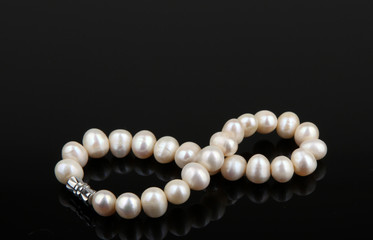 White pearls on black background