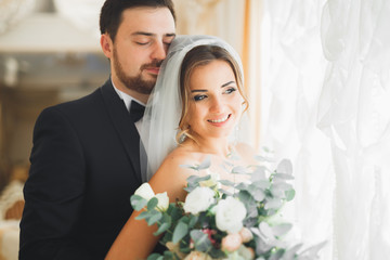 Wedding photo shoot of the newlyweds couple posing in a beautiful hotel