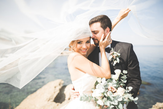 Happy And Romantic Scene Of Just Married Young Wedding Couple Posing On Beautiful Beach