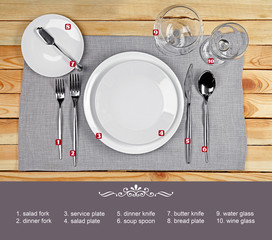 Beautiful table setting with white plates on wooden table